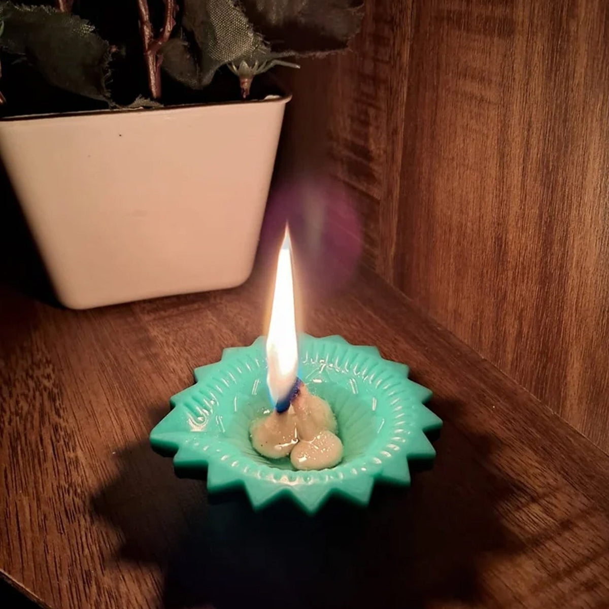 Close-up of two silicone diyas, one lit and one unlit, showcasing their craftsmanship.