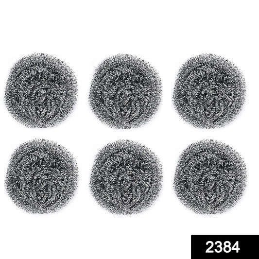 Heavy-duty stainless steel scrubber tackling tough grease on utensils.